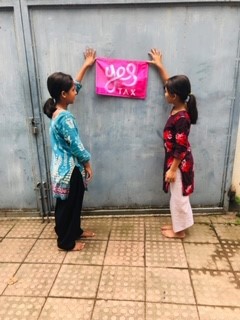 2 Children holding up a Yes Tax flag